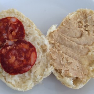 Bread roll with hummus and chorizo 